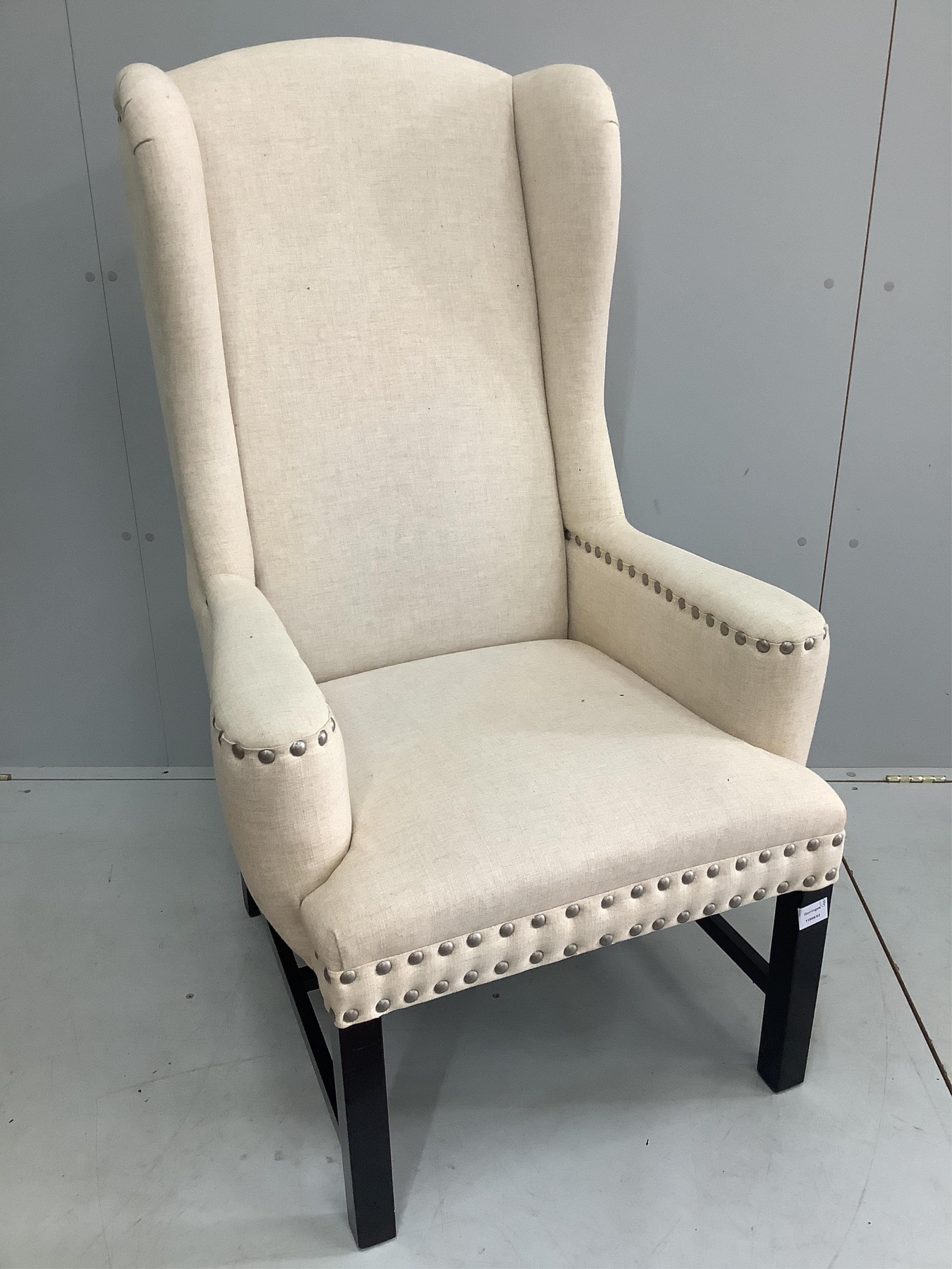 A cream canvas OKA wingback chair, width 72cm, depth 68cm, height 120cm. Condition - good